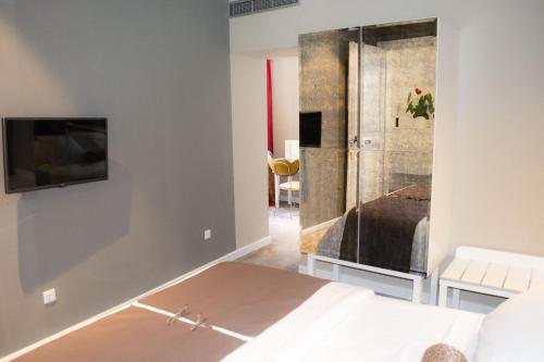 a bedroom with a bed and a tv on a wall at XII Century Heritage Hotel in Trogir