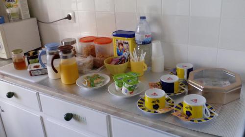 a counter with cups and plates of food on it at Tagus Host - 40308AL- 44211AL in Santarém