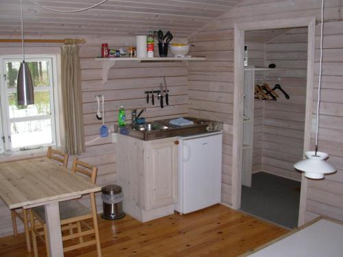 a kitchen with a sink and a table in a room at Gregersminde in Billund