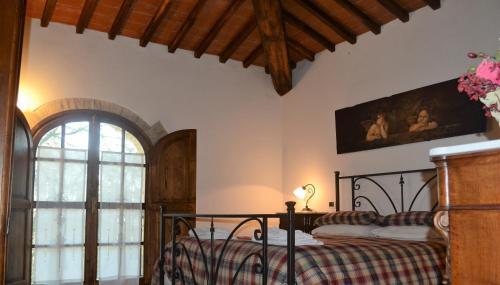 a bedroom with a bed and a window at Ala di Maniero in Agriturismo Valdrago in Toscana, nel Verde Mugello sulle Colline di Firenze Autodromo Mugello Circuit in Borgo San Lorenzo