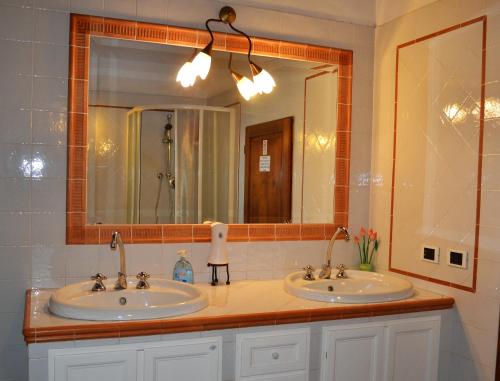 a bathroom with two sinks and a large mirror at Ala di Maniero in Agriturismo Valdrago in Toscana, nel Verde Mugello sulle Colline di Firenze Autodromo Mugello Circuit in Borgo San Lorenzo