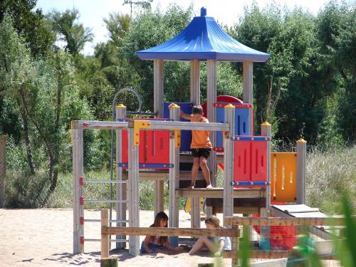 a boy and a girl playing on a playground at Camping Phare Ouest in Saint-Denis-dʼOléron