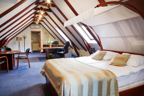 a bedroom with a bed and a desk in a room at Rezydencja Solei Old Town in Poznań