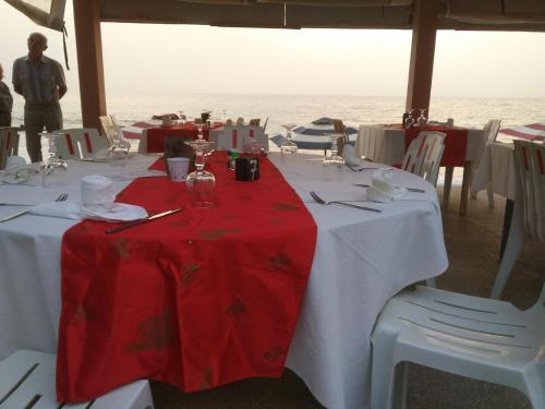 a table with a red and white table cloth at Africa 6 Plage in Somone