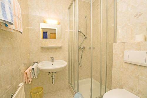 a bathroom with a shower and a sink and a toilet at Haus Gsenger in Eben im Pongau