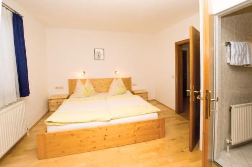 a bedroom with a large bed in a room at Haus Gsenger in Eben im Pongau