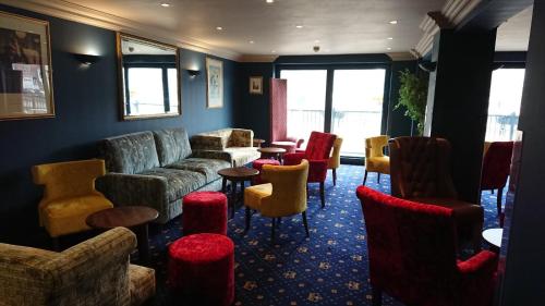 a living room filled with furniture and a red carpet at The Queens Hotel in York