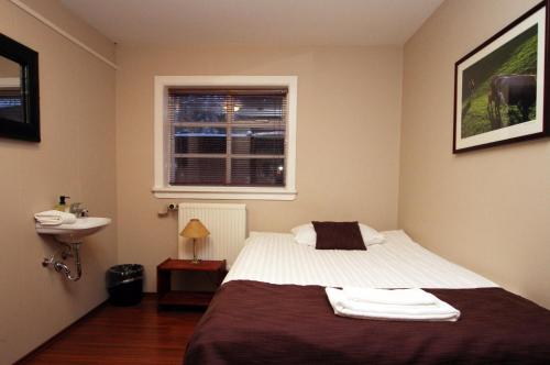 Łóżko lub łóżka w pokoju w obiekcie Guesthouse Grai Hundurinn