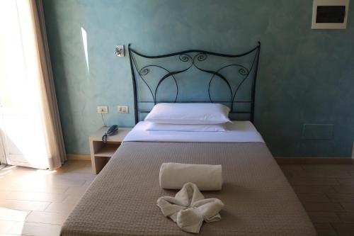 a bedroom with a bed with a bow on it at Hotel La Madonnina in Milan