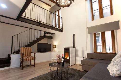 a living room with a couch and a fire place at Casa Severina in Alcoy