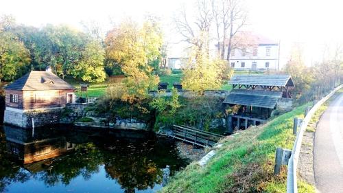 a view of a river with a house on it at U Leknínu in Doksy