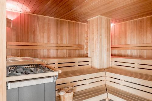 a sauna with wood paneling and a stove in it at Apartment Torri di Seefeld in Seefeld in Tirol