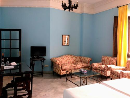 a living room with two couches and a tv at Hotel Casa Imperial in Seville