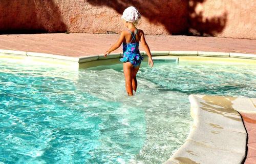 a young girl walking in a swimming pool at Azur et Neige in Saint-Jean