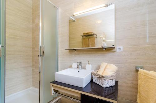 a bathroom with a sink and a mirror at Beautiful Countryside Villa in Gruda