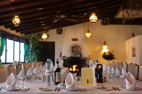 a table with chairs and bottles of wine on it at Aeromar Beach Hotel in Faro