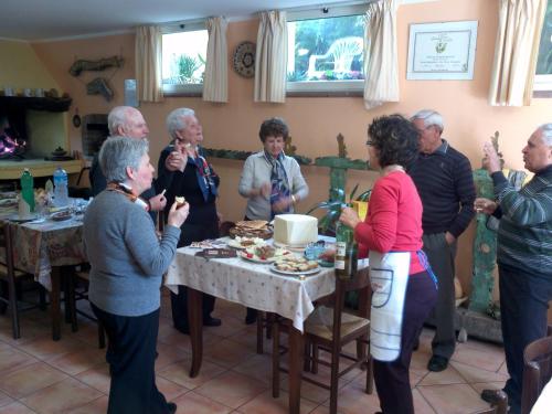 a group of people standing around a table at Su Livariu in Siamaggiore