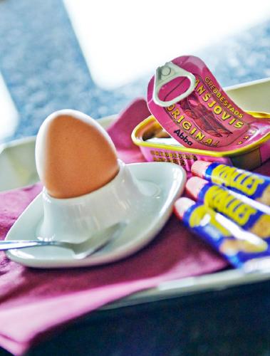 a egg in a spoon on a plate with candy at Hotel Surte in Surte