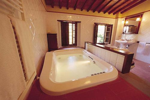 a bathroom with a large tub in a room at Monsignor Della Casa Country Resort & Spa in Borgo San Lorenzo