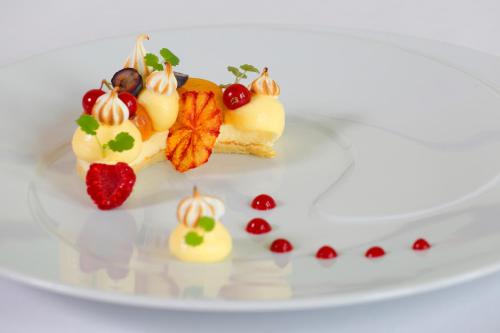 a white plate with a dessert with fruit on it at Château de Pizay in Belleville-sur-Saône
