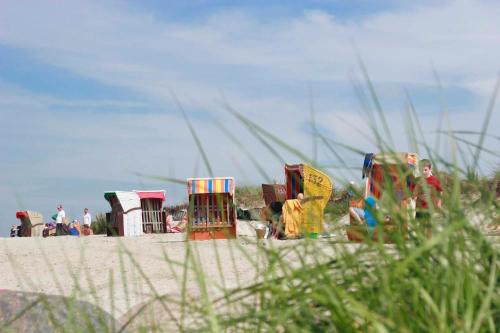 a group of colorful play structures on a beach at Steiner Strandappartements Appartement 202 Seeseite in Stein