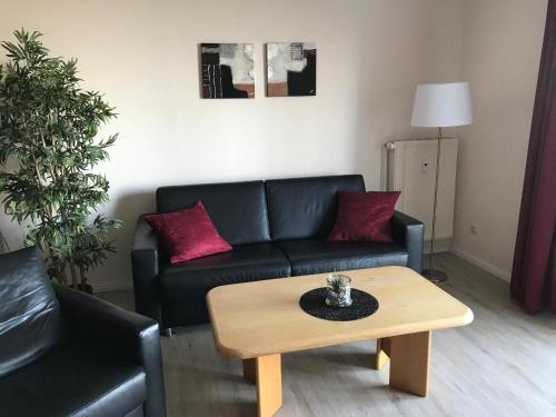 a living room with a couch and a coffee table at Steiner Strandappartements Appartement 202 Seeseite in Stein