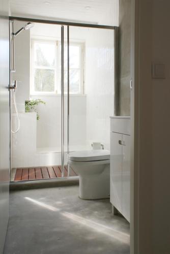 a white bathroom with a tub and a shower at Casa de Baixo in Coimbra