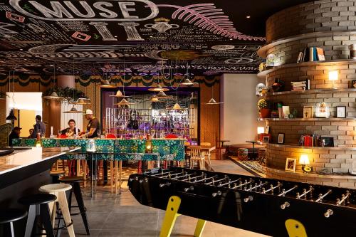 a bar with a green counter in a restaurant at Mama Shelter Belgrade in Belgrade
