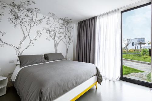 a bedroom with a bed and a large window at Masseria Guida in Ercolano