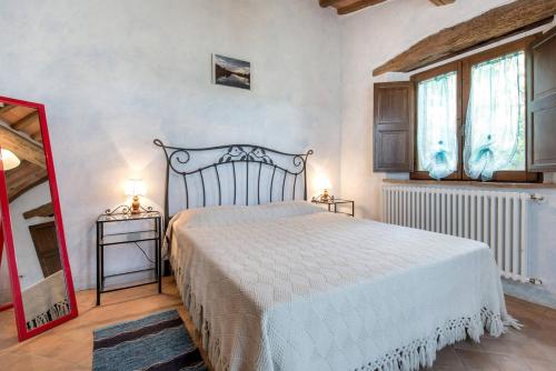 Säng eller sängar i ett rum på La villa della quercia