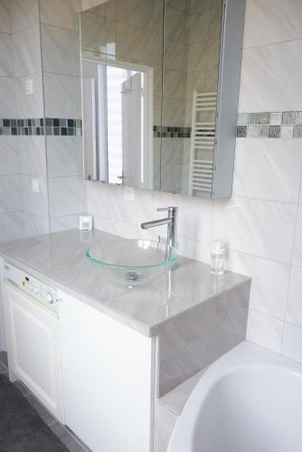 a bathroom with a sink and a mirror at Avenue de La Paix - L'Exclusif in Strasbourg