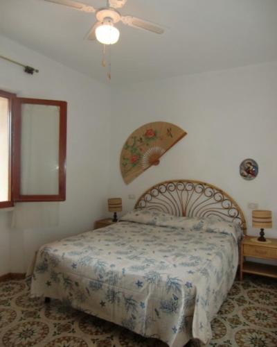 a bedroom with a bed and a ceiling fan at Ammiraglio in Campese