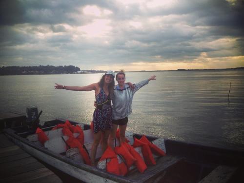 two women standing in a boat on the water at Typical House Bluefields in Bluefields