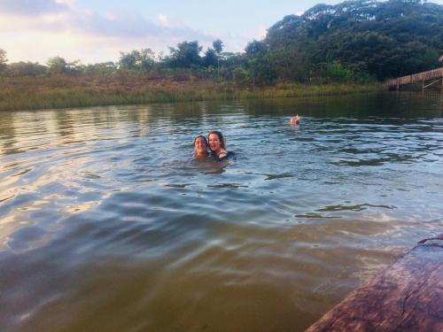 two people swimming in the water in a lake at Typical House Bluefields in Bluefields