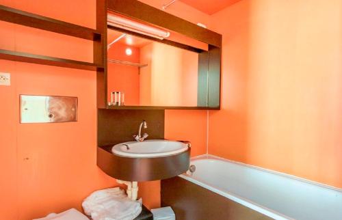 a bathroom with a sink and a bath tub at Residence Les Portes du Soleil - maeva Home in Avoriaz