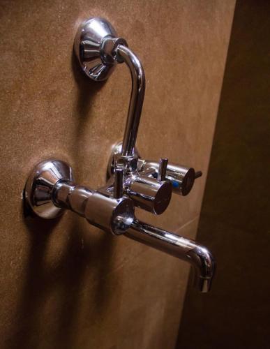 a metal doorhandle on a door with a handle at Nexstay Crystal Residency in Kozhikode