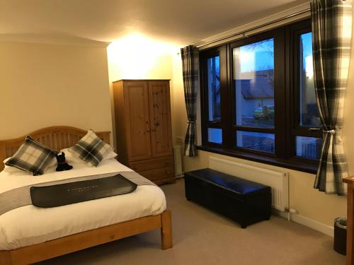 a bedroom with a bed and a large window at Ben Nevis Guest House in Fort William