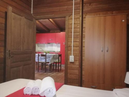 a room with a bed and a kitchen with a table at Campeggio Italia in Marina di Massa