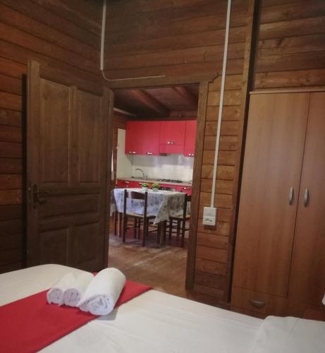 a bedroom with a bed and a kitchen with a table at Campeggio Italia in Marina di Massa