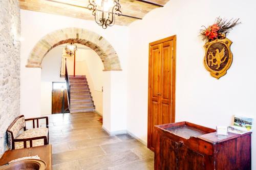 a hallway with a wooden door and a staircase at Borgo San Pietro in Agnone