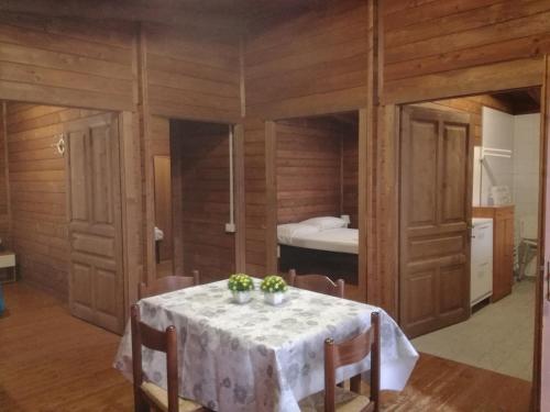 a dining room with a table and a bed at Campeggio Italia in Marina di Massa