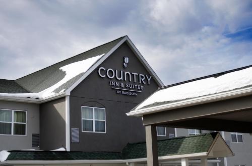 a building with a sign for a country inn and suites at Country Inn & Suites by Radisson, Ithaca, NY in Ithaca