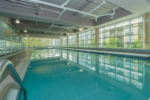 a large swimming pool in a large building at 2 Bedroom No 3.Rd Apartment Skytrain in Richmond