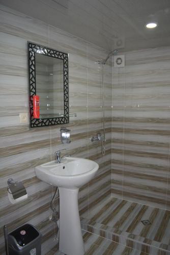 a bathroom with a sink and a mirror at Millennium Rabati in Akhaltsikhe