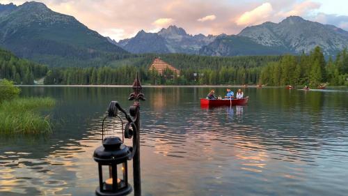 a group of people in a boat on a lake at Apartmán Crocus 313 in Štrbské Pleso