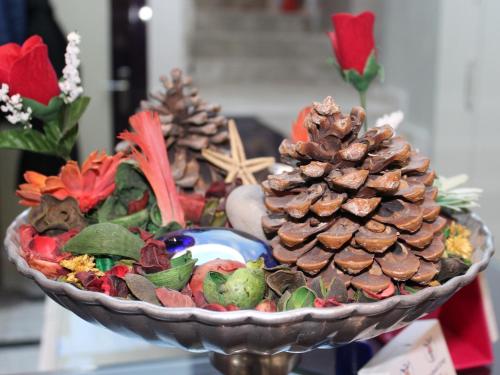 a plate of food with a pine cone on it at Laleli Hotel Izmir in İzmir