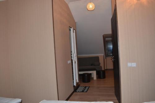 a hallway with a door to a room with a couch at Millennium Rabati in Akhaltsikhe