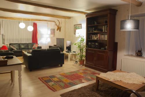 a living room with a couch and a table at Beautiful and Spacious Contemporary house in Oignies-en-Thierache