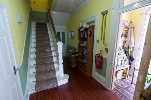 a hallway with a staircase in a house at Harbour Heights Guest House in Torquay