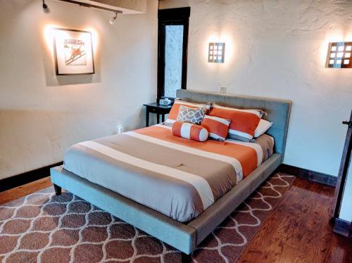 a bedroom with a large bed with orange pillows at Vail View Loft - Slope-view condo, free bus for quick access to Vail Village in Vail